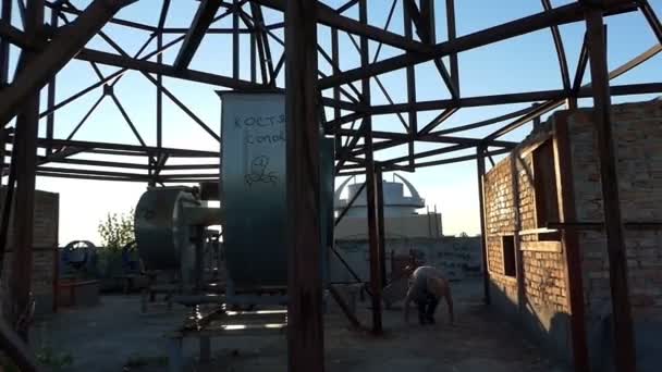 Happy man on a construction site does a push up, jumps in slo-mo — Stock Video