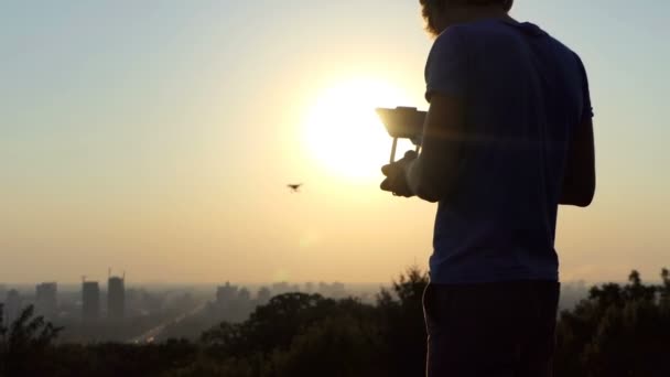 El camarógrafo inteligente usa un cuadracóptero volador al atardecer en slo-mo — Vídeo de stock