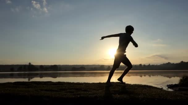 Joven baila disco en una orilla del lago en verano — Vídeo de stock