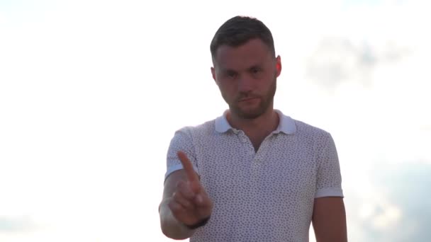 Serious guy shows rejection gesture and gesture away in slow motion — Stock Video