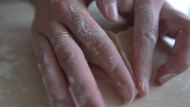 Τα χέρια των κοριτσιών φτιάχνουν μια τριγωνική πίτα από τη ζύμη. — Αρχείο Βίντεο