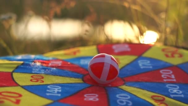 Velcro balls, target , close up at sunset in slow motion. — Stock Video
