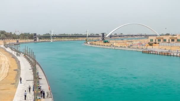 Two bridges over newly opened Dubai canal with a boat crossing under them timelapse. — Stock Video