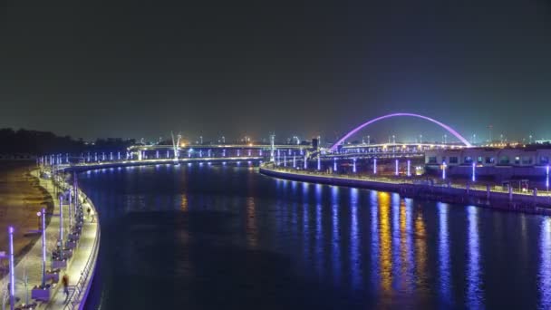 Two bridges over newly opened Dubai canal with a boat crossing under them timelapse. — Stock Video