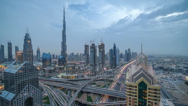 View on modern skyscrapers and busy evening highways day to night timelapse in luxury Dubai city, Dubai, United Arab Emirates — Stock Video