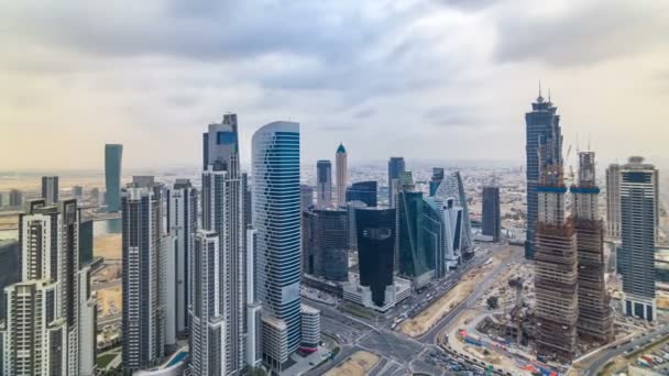 Dubais business bay towers before sunset timelapse. Rooftop view of some skyscrapers and new towers under construction. — Stock Video