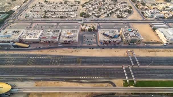 Aerial view of Sheikh Zayed highway road timelapse in Dubai with traffic and a metro station. — Stock Video