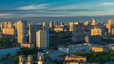 Moscow city bathed in yellow sun at dawn timelapse. An early foggy morning. Shadows moving on houses. Megalopolis aerial view from rooftop.