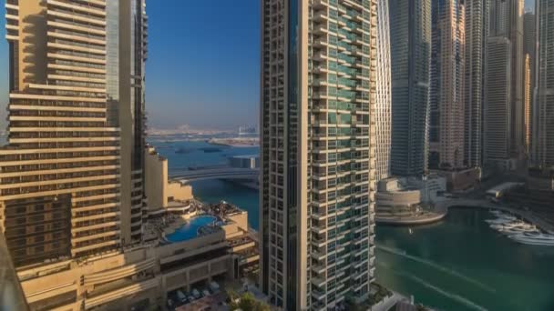 View of modern skyscrapers shining in sunrise lights timelapse in Dubai Marina in Dubai, UAE. — Stock Video