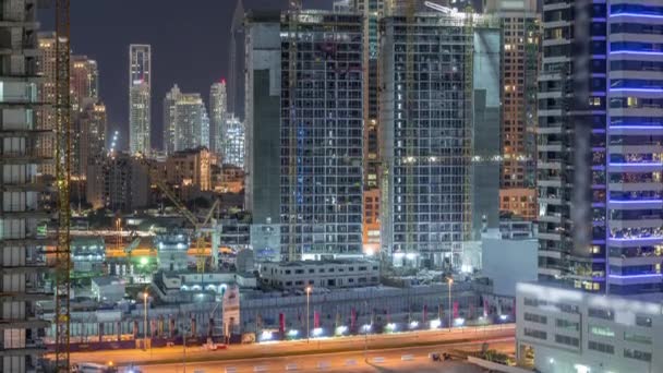 Aerial view of constructing with cranes night timelapse in Dubai. — Stock Video