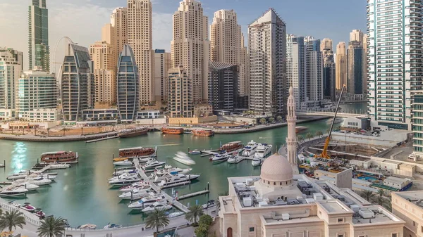 Yachts in Dubai Marina flanked by the Al Rahim Mosque and residential towers and skyscrapers aerial timelapse. — Stock Photo, Image