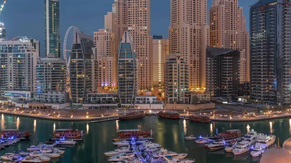 Luxury yachts parked on the pier in Dubai Marina bay with city aerial view night to day timelapse — Stock Photo, Image