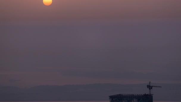 Sunrise close up view over Dubai skyline in the morning, aerial top view from downtown timelapse. — Stock Video