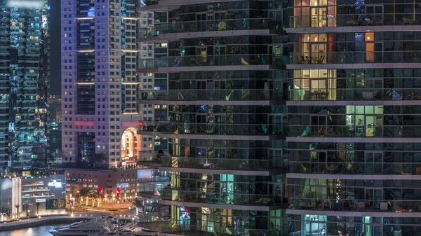 Aerial view of Dubai Marina residential and office skyscrapers with waterfront night timelapse — ストック写真