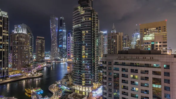 Aerial view of Dubai Marina residential and office skyscrapers with waterfront night timelapse — ストック写真