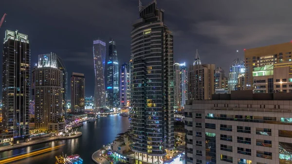 Aerial view of Dubai Marina residential and office skyscrapers with waterfront night timelapse — Stock Photo, Image