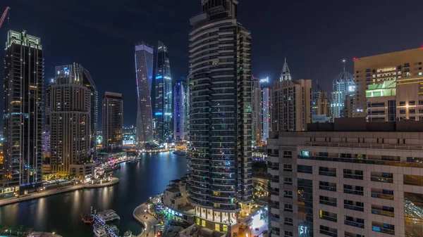 Aerial view of Dubai Marina residential and office skyscrapers with waterfront night timelapse — Stock Photo, Image