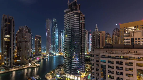 Aerial view of Dubai Marina residential and office skyscrapers with waterfront night timelapse — ストック写真