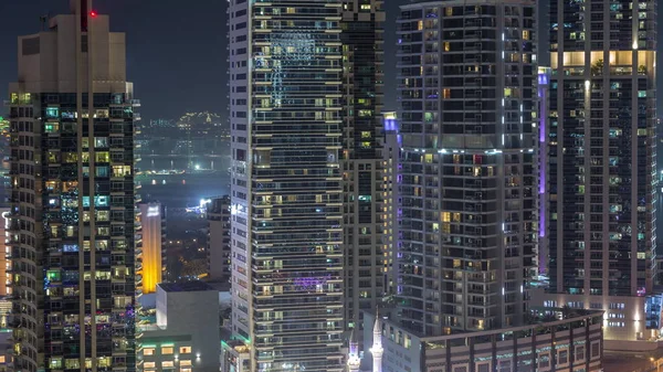 View of various skyscrapers and towers in Dubai Marina from above aerial night timelapse — ストック写真