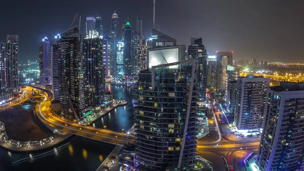 Aerial view of Dubai Marina residential and office skyscrapers with waterfront night timelapse — Stock Photo, Image