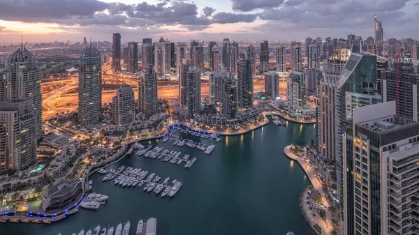 Dubai Marina skyscrapers and jumeirah lake towers view from the top aerial night to day timelapse in the United Arab Emirates. — Stock Photo, Image