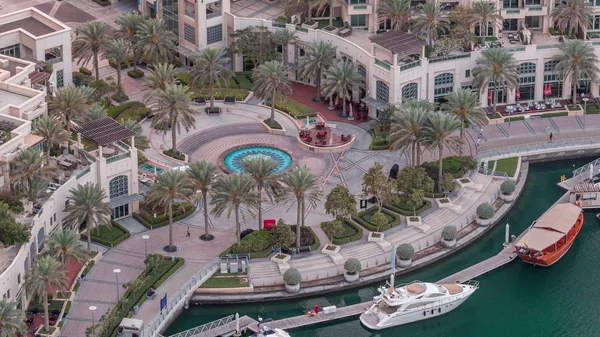 Dubai Marina Walk with fountain and palms aerial Top View night to day timelapse — стоковое фото