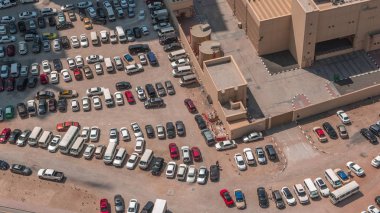 Aerial view full cars at large outdoor parking lots timelapse in Dubai, UAE. clipart