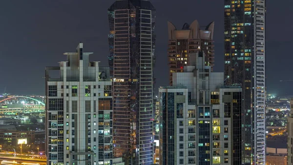 Vista nocturna de las luces de los rascacielos por la noche en Dubai timelapse aéreo —  Fotos de Stock
