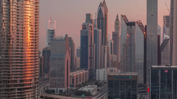 Dubai International Financial Centre district with modern skyscrapers timelapse at sunrise — Stock Photo, Image