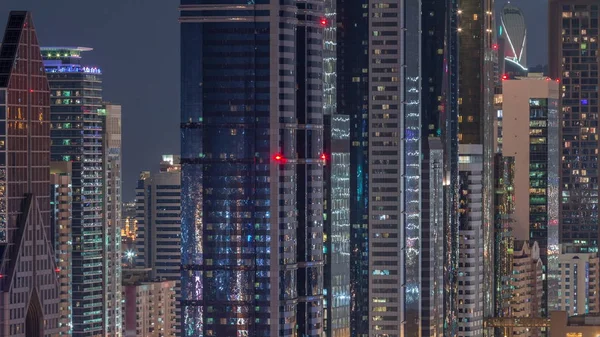Dubai International Financial Centre district with modern skyscrapers night timelapse — Stock Photo, Image