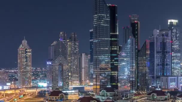 Aerial view of illuminated skyscrapers and road junction in Dubai timelapse — Stock Video