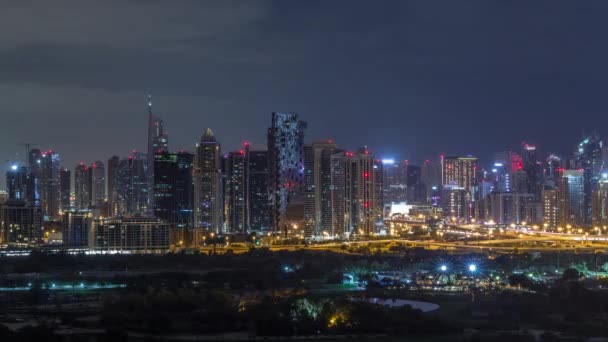 Jumeirah Lake towers and Dubai marina skyscrapers and golf course during all night timelapse, Dubai, United Arab Emirates — стоковое видео