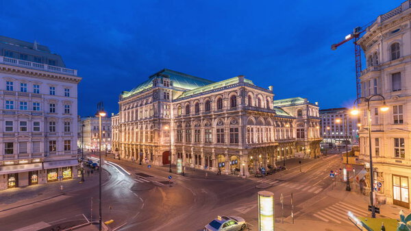 Beautiful view of Wiener Staatsoper (Vienna State Opera) aerial day to night transition timelapse in Vienna, Austria. Illuminated historic buildings and traffic on streets