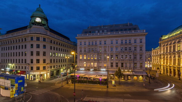 Albertina Square aerial day to night transition timelapse with illuminated historic buildings, tourist buses, people and traffic in downtown Vienna, Austria