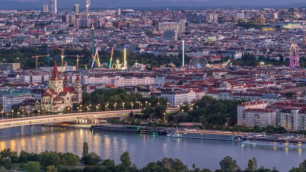 Aerial panoramic view over Vienna city with skyscrapers, historic buildings and a riverside promenade day to night timelapse in Austria. — Stock Photo, Image