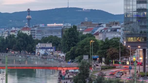 Aerial view along the Danube Canal in Vienna day to night timelapse after sunset — Stock Video