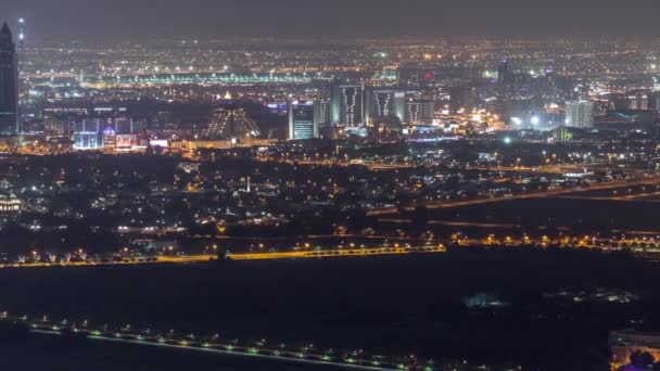 Aerial view to Creek and zabeel district night timelapse with traffic and under construction building with cranes from downtown — Stock Video