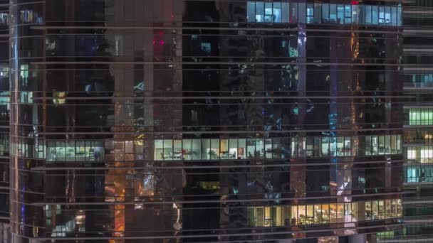 Office skyscraper exterior during late evening with interior lights on and people working inside night timelapse — Stock Video