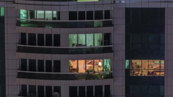 Vista nocturna del apartamento exterior timelapse edificio. Rascacielos de gran altura con luces intermitentes en las ventanas — Vídeos de Stock