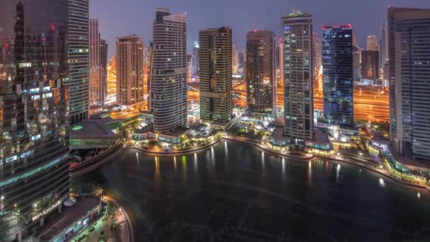 Residentiële en kantoorgebouwen in Jumeirah Lake Towers district Night to Day timelapse in Dubai — Stockvideo