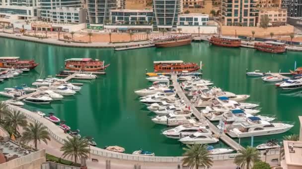 Luxury yachts parked on the pier in Dubai Marina bay with city aerial view timelapse — Stock Video