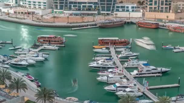 Luxury yachts parked on the pier in Dubai Marina bay with city aerial view timelapse — Stock Video