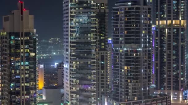 View of various skyscrapers and towers in Dubai Marina from above aerial night timelapse — ストック動画