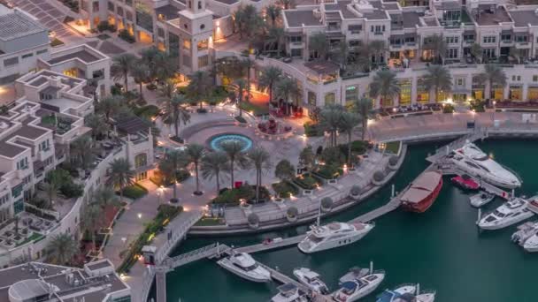 Dubai Marina Walk with fountain and palms aerial Top View night to day timelapse — стоковое видео