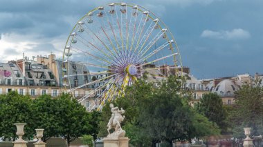 Ferris wheel (Roue de Paris) on Tuileries Garden timelapse. Paris, France. Tuileries Palace is open air park near Louvre museum. Cloudy summer day clipart