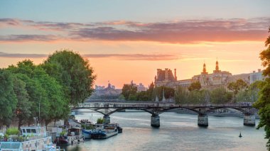 View on Pont des Arts in Paris at sunset timelapse from Pont Neuf, France. Ship on the River Seine near square of the Vert-Galant clipart