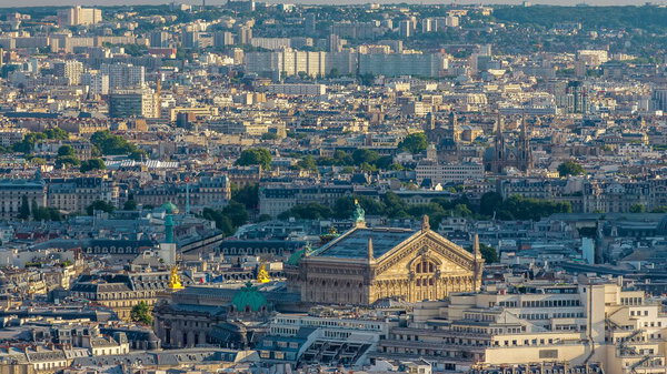 Panorama of Paris timelapse, France. Top view from Sacred Heart Basilica of Montmartre (Sacre-Coeur). With Garnier opera. Sunny day with blue cloudy sky.