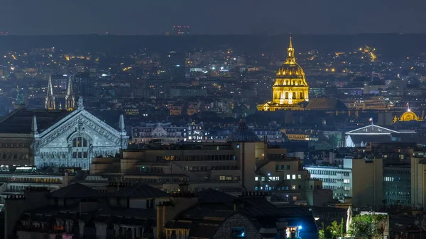 Beautiful Paris night cityscape timelapse seen from Montmartre with Garnier opera and Les Invalides. Top view from viewpoint. Paris, France