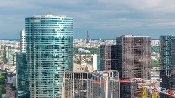 View of Paris and Eiffel Tower timelapse from the top of the skyscrapers in Paris business district La Defense. Sunny summer day. Paris, France