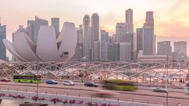 Aerial view over Helix Bridge and Bayfront Avenue with traffic day to night timelapse at Marina Bay, Singapore — Stock video